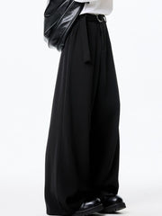 Men's black wide-leg casual pants with belted waist and silver buckle detail.