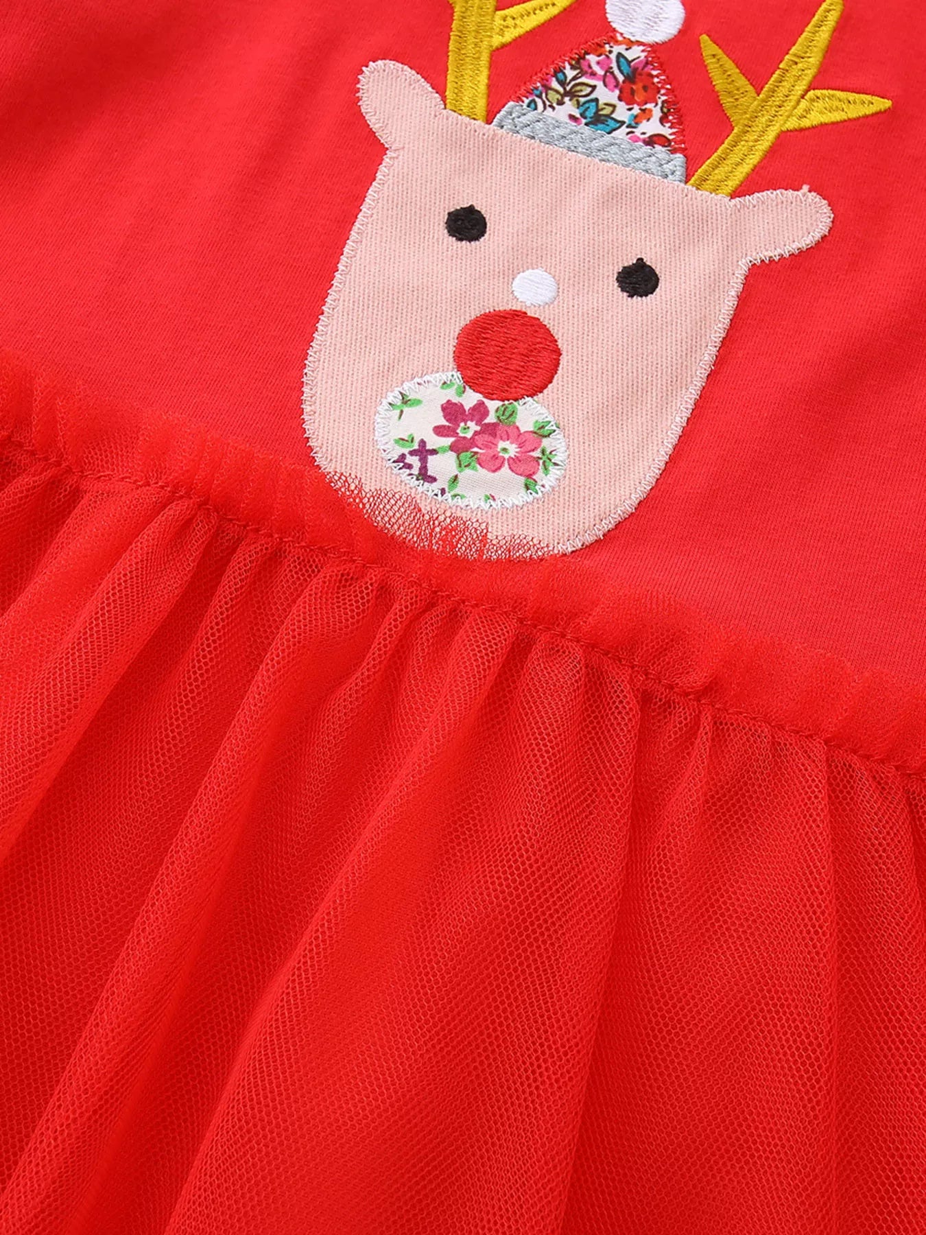 Red children's reindeer applique tulle dress with floral detail.