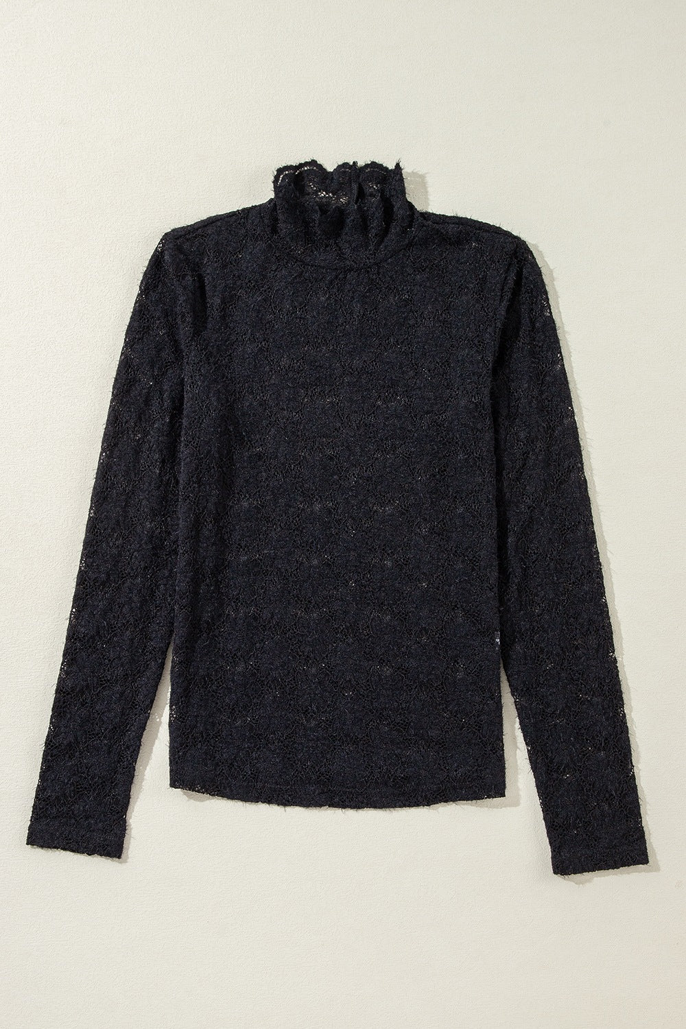 Black floral lace turtleneck top with ruffled neckline and long sleeves.
