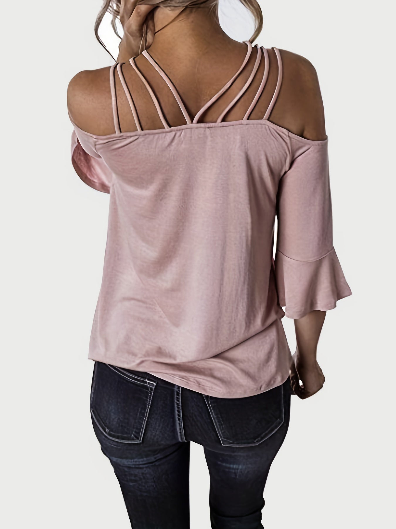 Blush pink blouson top with strappy shoulders and flared sleeves.