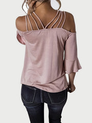 Blush pink blouson top with strappy shoulders and flared sleeves.