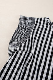 Black gingham blouse with ruffled mock neck and ruffle sleeves.