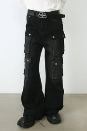 Dark oversized denim cargo pants with multiple pockets and a flared leg.