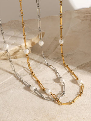 Two-tone pearl link necklace in silver and gold with oval chain links and white pearls.
