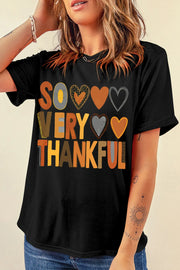 Black graphic t-shirt with "So Very Thankful" text and heart graphics.