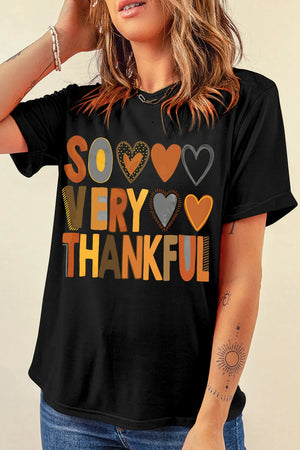 Black graphic t-shirt with "So Very Thankful" text and heart graphics.