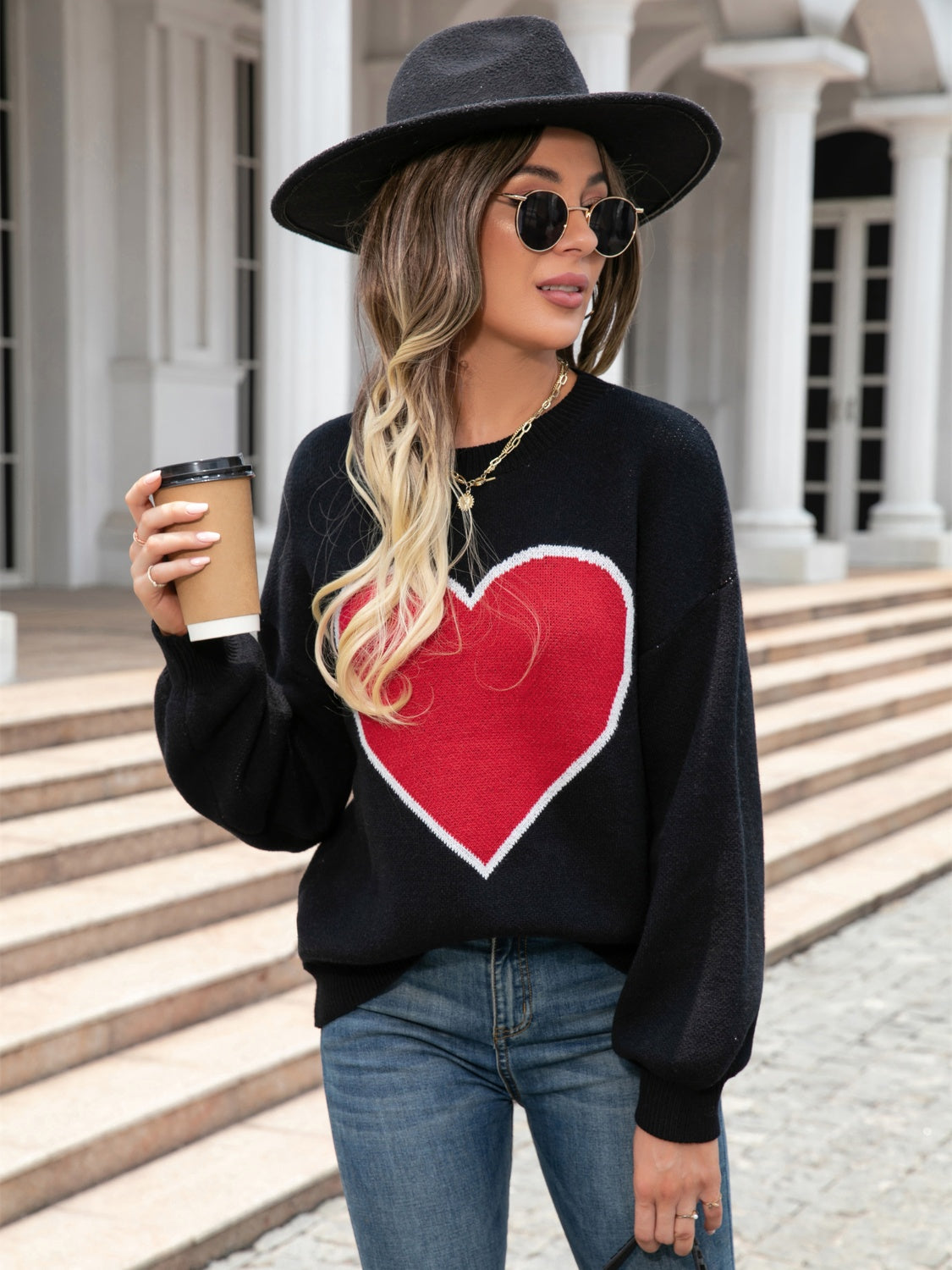 Black acrylic sweater with red heart motif and balloon sleeves
