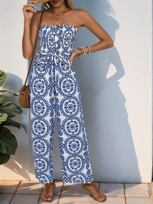 Bustier print wide leg jumpsuit in blue with decorative buttons and tie waist.