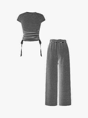 Black and white striped crop top with adjustable tie sides and matching wide-leg pants.