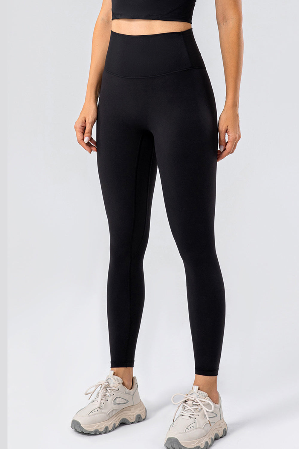 Black high-waist performance leggings with a seamless contour design.
