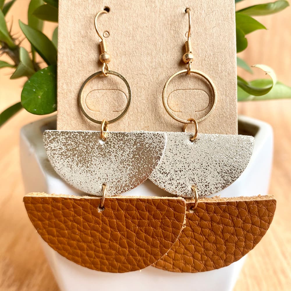 Textured leather & metallic half-moon earrings with gold hoops.