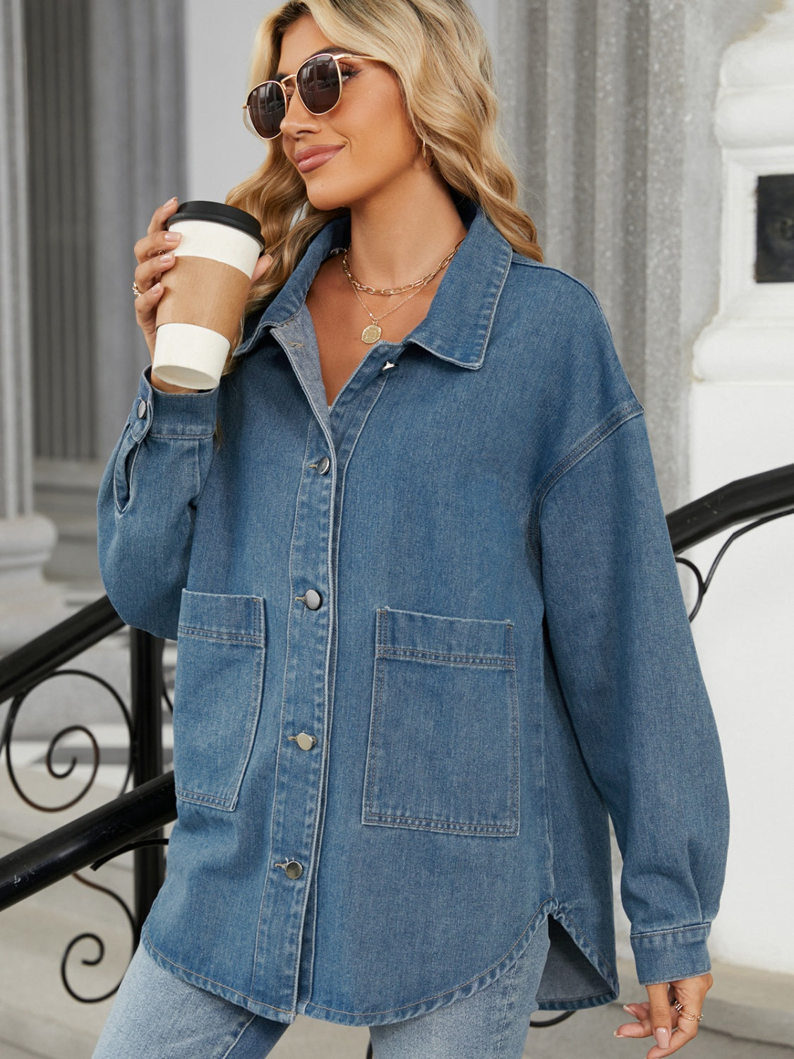 Medium wash oversized denim jacket with hood, button front, and chest pockets.