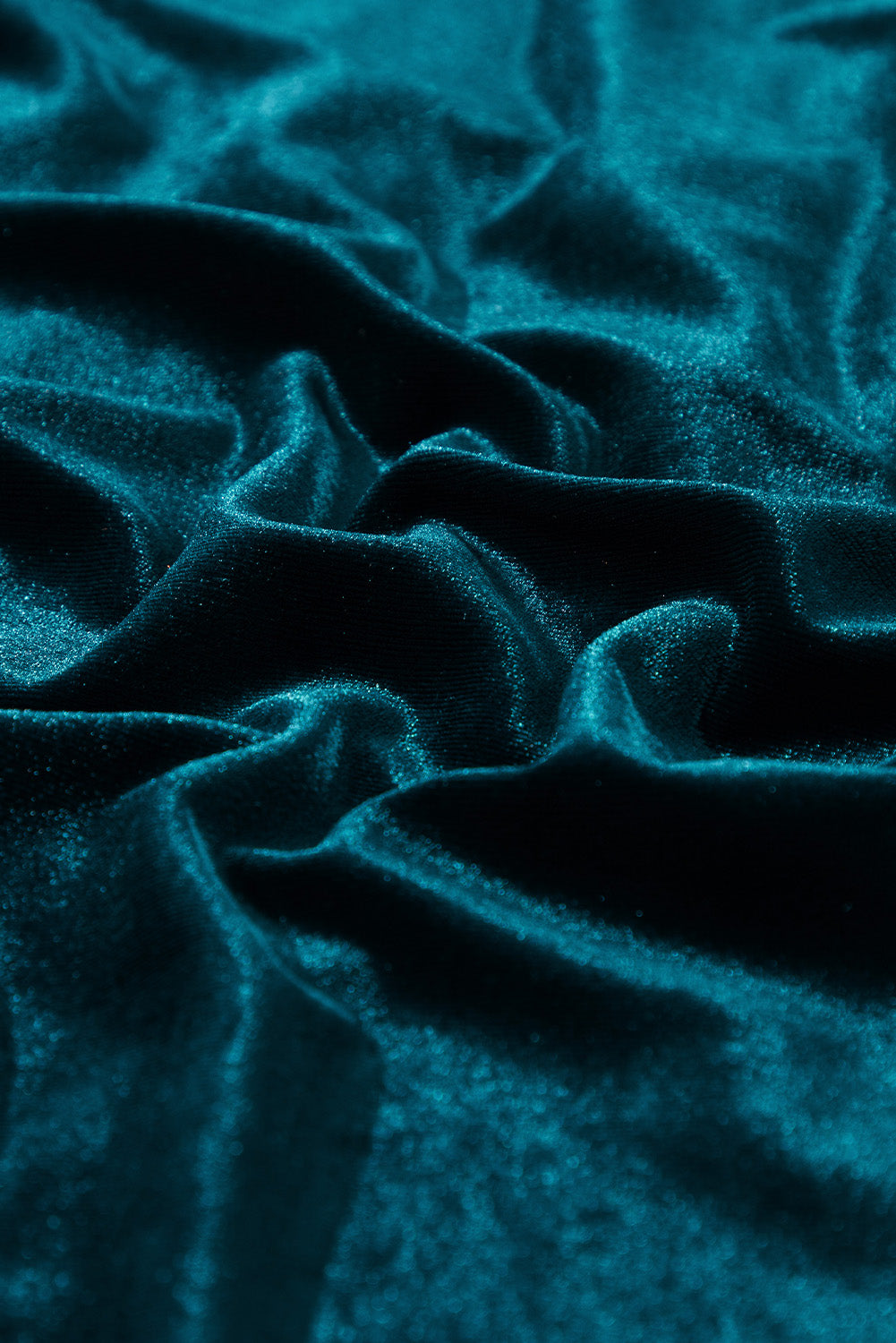 Gathered velvet henley blouse in deep teal with soft draping.