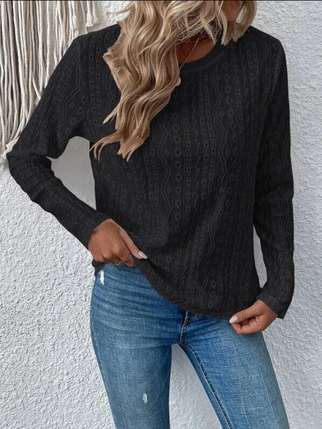 Black geometric eyelet long sleeve knit top with crew neck.