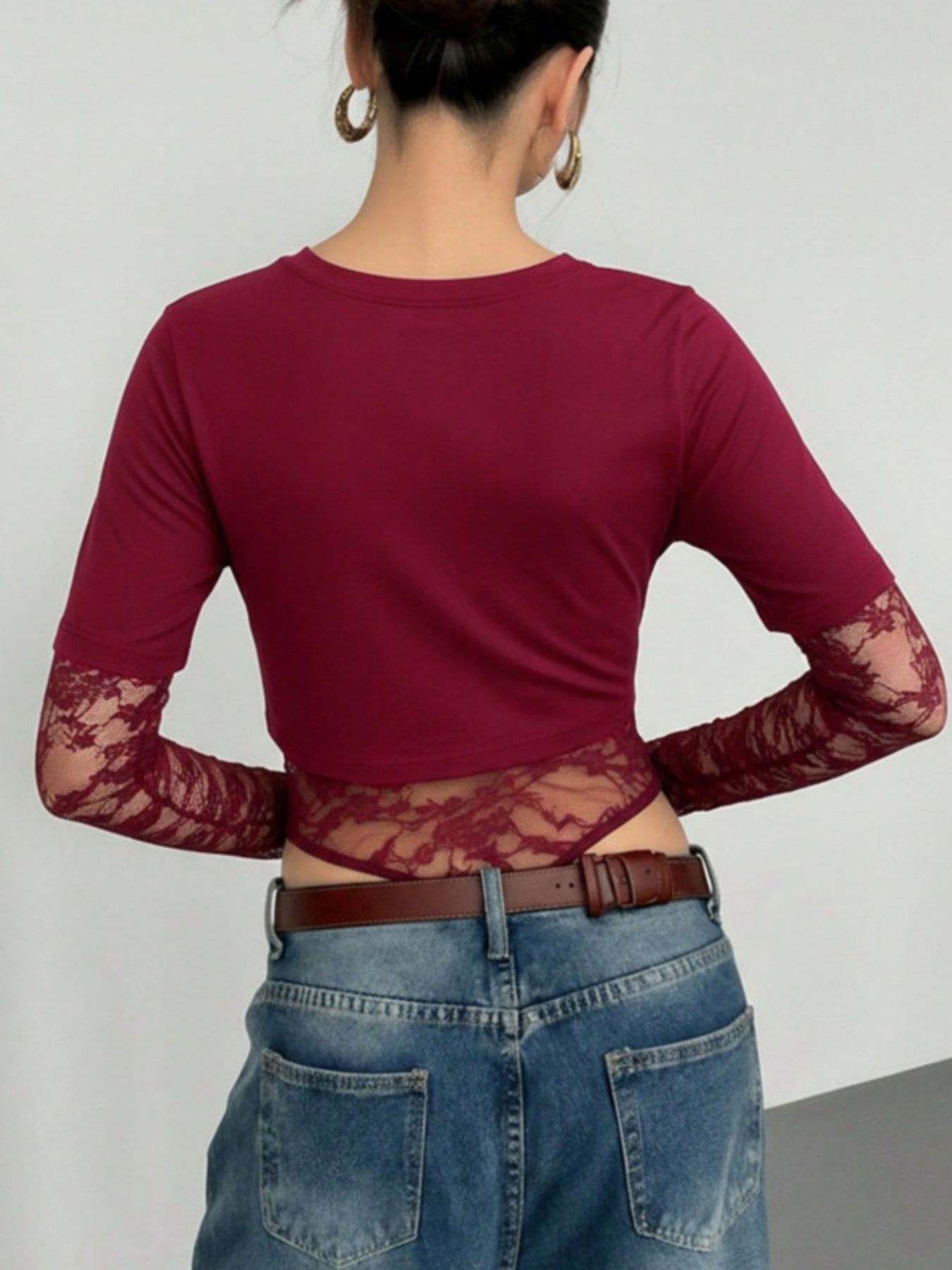 Wine red lace patchwork bodysuit with sheer lace sleeves and bottom detail.