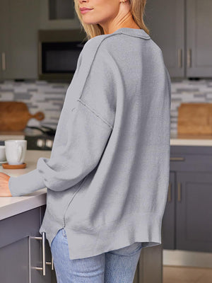 Gray ribbed-knit relaxed fit sweater with a collared neckline and dropped shoulders.