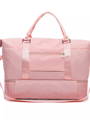 Light pink duffel bag with multiple zippered pockets and adjustable straps.
