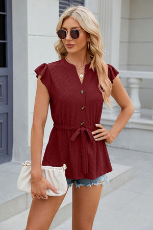 Burgundy textured eyelet peplum blouse with tie waist and flutter sleeves.