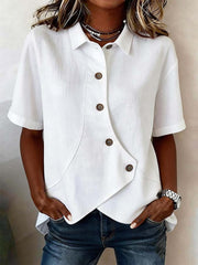 White asymmetrical button front shirt with short sleeves and a diagonal placket.