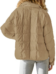 Camel quilted bomber jacket with stand collar and boxy cut.