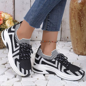 Geometric knit platform sneakers in black and white with lace-up closure and chunky sole.