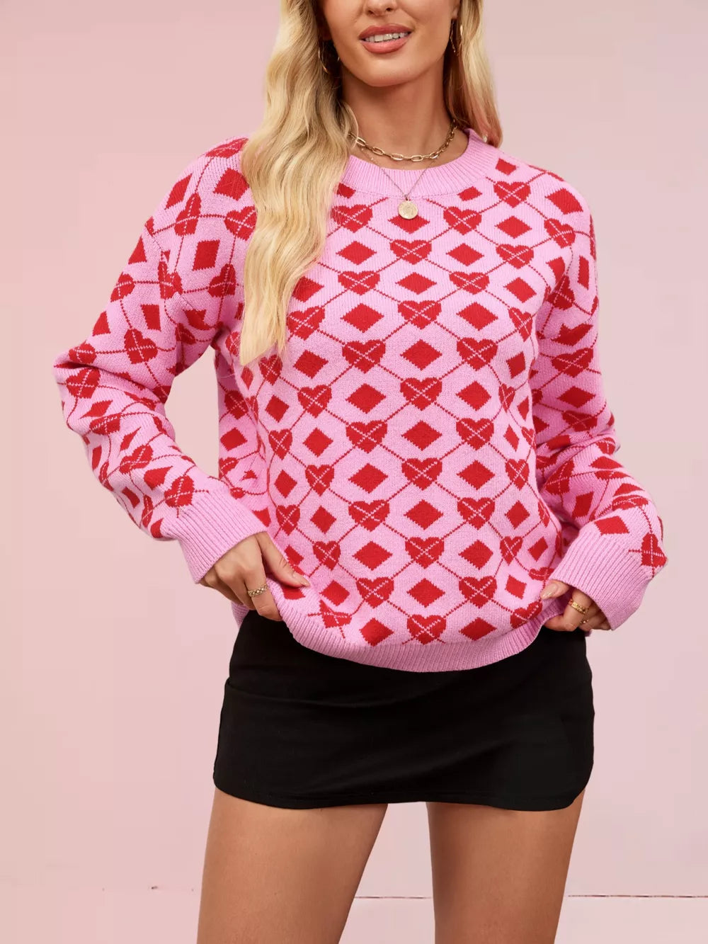 Pink argyle knit sweater with red hearts, crew neck, long sleeves.