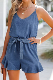 Medium wash denim romper with tie waist and ruffled hem