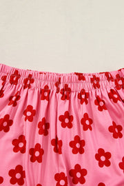Pink floral crop top & shorts set with red flower pattern and elastic waistband.