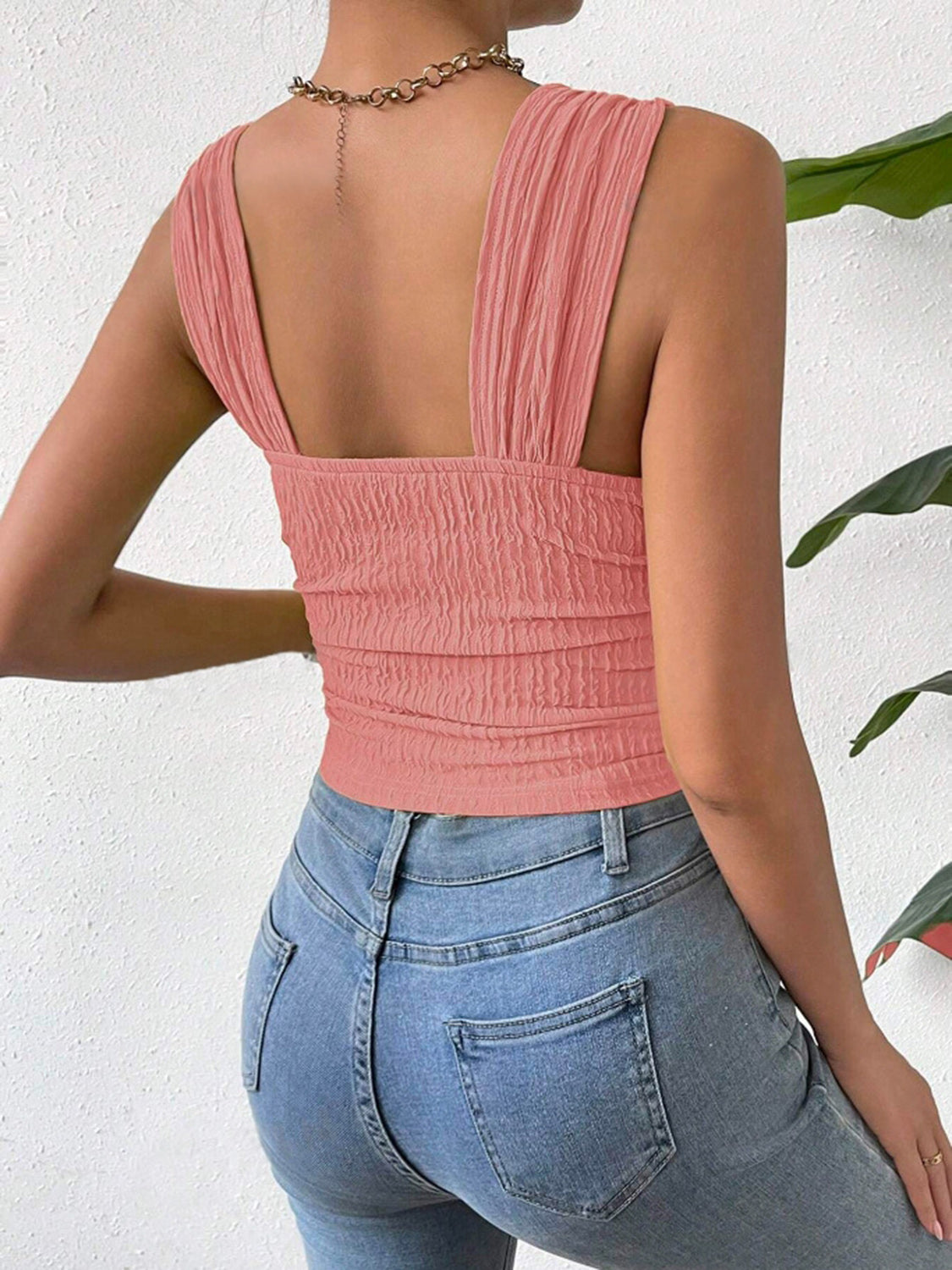 Textured crinkle strap crop top in coral with ruched detail.