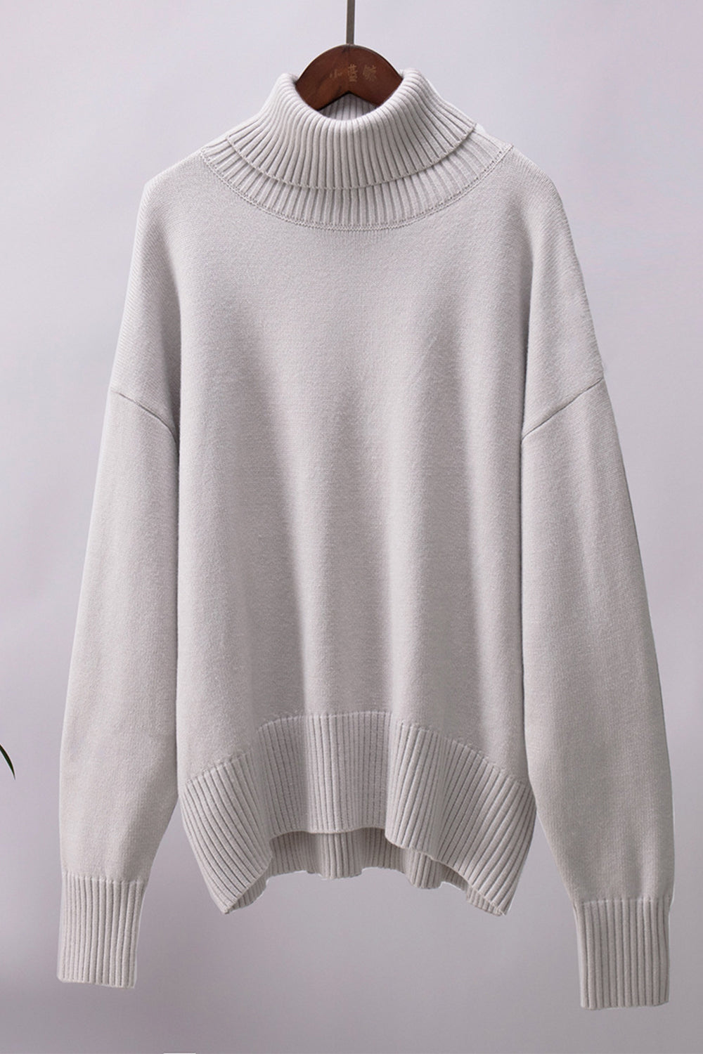 Light Gray relaxed roll-neck sweater with a boxy knit and ribbed details.