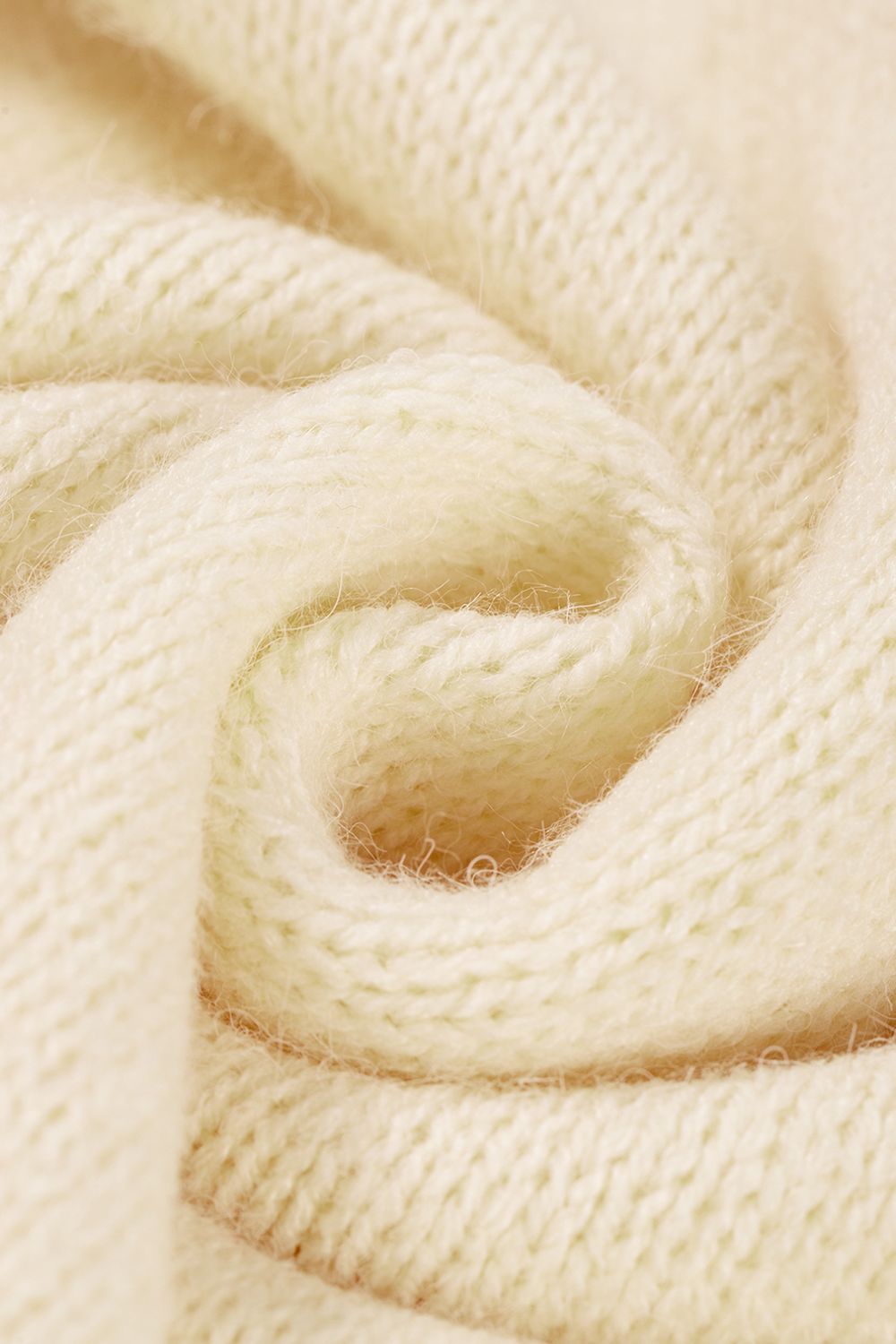 Cream acrylic knit sweater with a textured stitch detail.