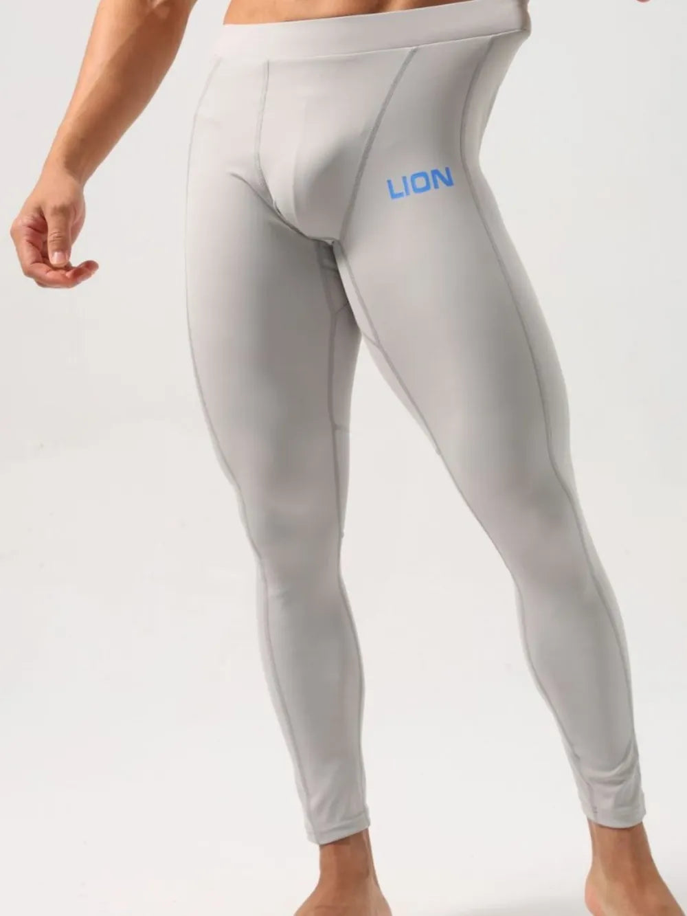 Gray performance compression tights with blue LION logo and contrast stitching