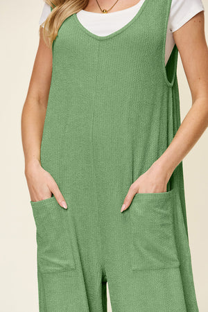 Light green ribbed knit tie-strap jumpsuit with V-neck and patch pockets.