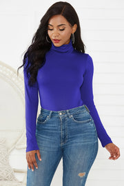 Royal Blue turtleneck thong bodysuit with long sleeves, styled with high-waisted jeans.