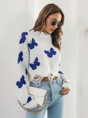 White cropped knit sweater with blue distressed butterfly print and frayed hem.