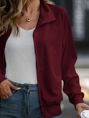 Burgundy ribbed zip-up jacket with raglan sleeves and collar detail.