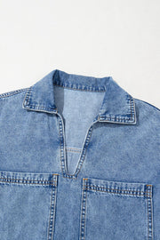 Light blue denim mini dress with collar, V-neck, and two chest pockets.