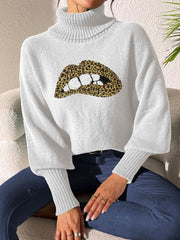White turtleneck sweater with sequin leopard print lips detail and balloon sleeves.