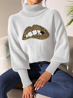 White turtleneck sweater with sequin leopard print lips detail and balloon sleeves.
