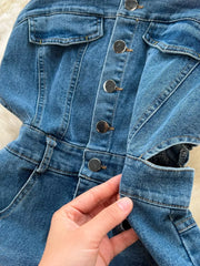 Denim maxi dress with button front, chest pockets, and cutout detail.