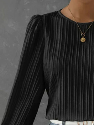 Black pleated blouse with gathered shoulders and crew neck.