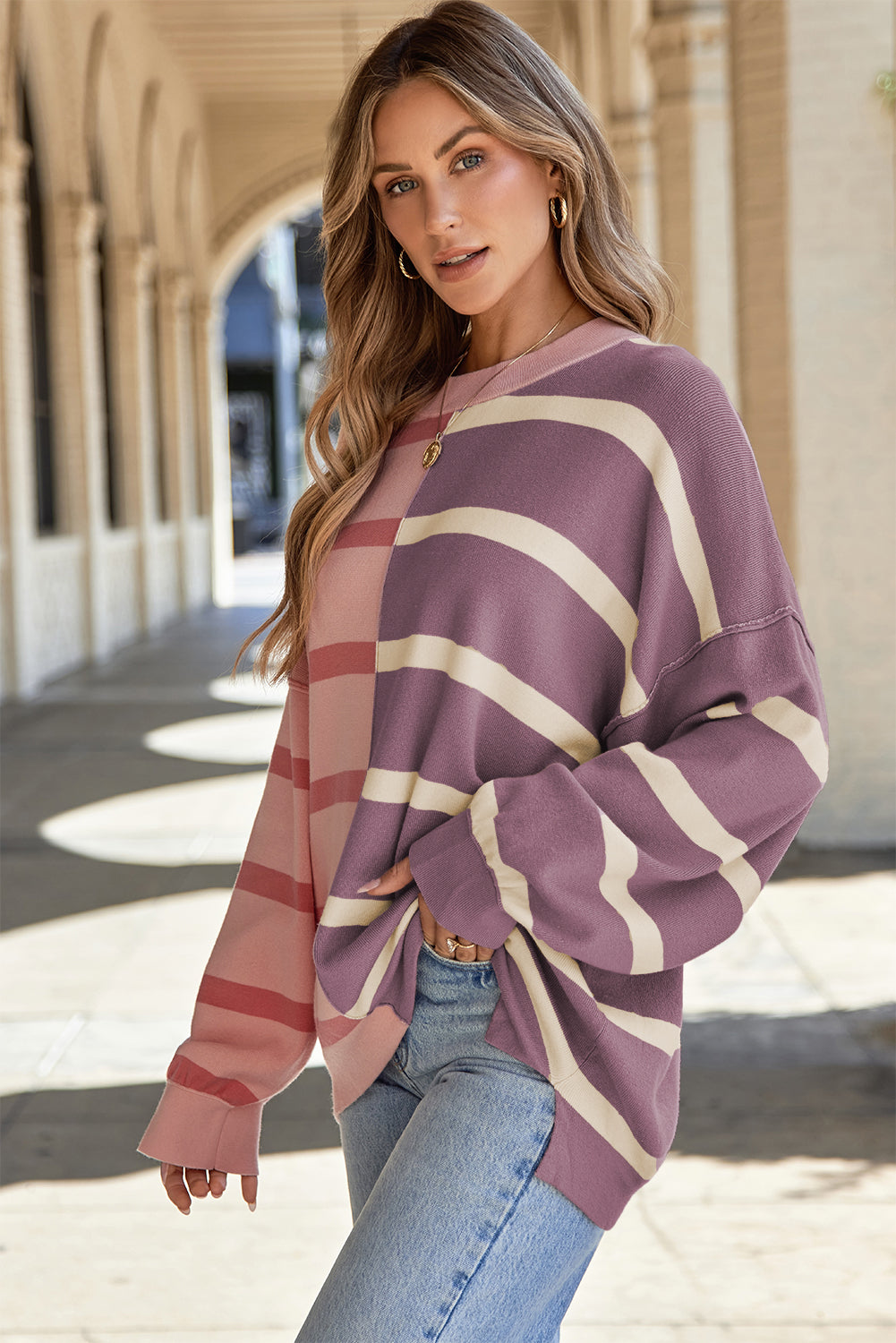Colorblock stripe knit pullover sweater with crew neck and long sleeves.