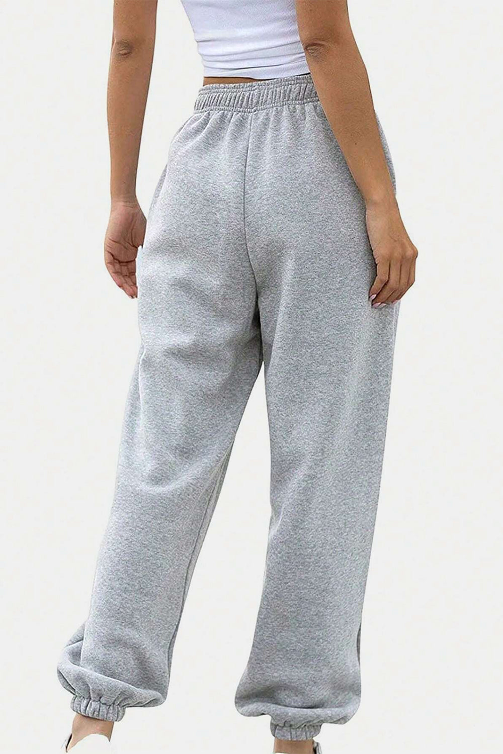 Light gray relaxed-fit sweatpants with elastic waistband and cuffed ankles.
