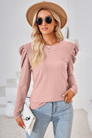Blush pink textured crew neck top with puff sleeves and diamond pattern
