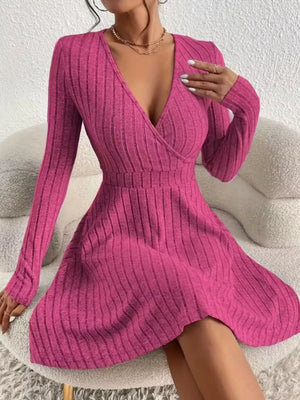 Fuchsia pink ribbed wrap mini dress with long sleeves and a V-neckline.