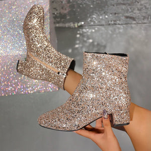 Gold sequin ankle boots with a side zipper and block heel.