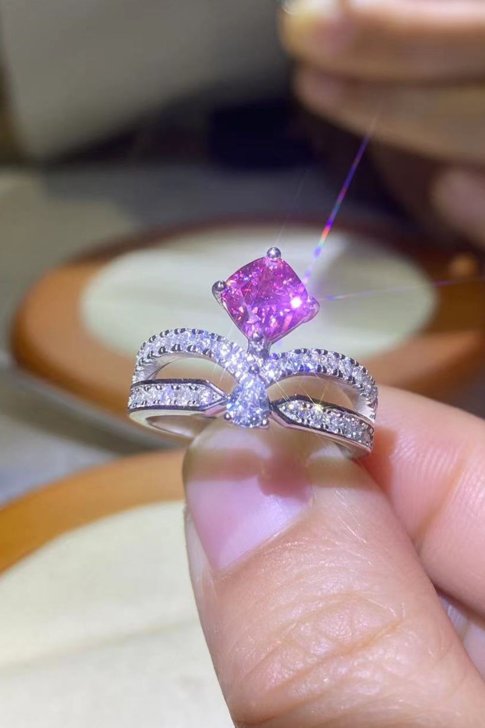 Pink moissanite bow ring in sterling silver with pavé detail