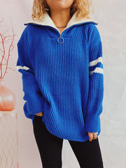 Royal blue ribbed knit sweater with white varsity stripes on sleeves and a white zippered collar.