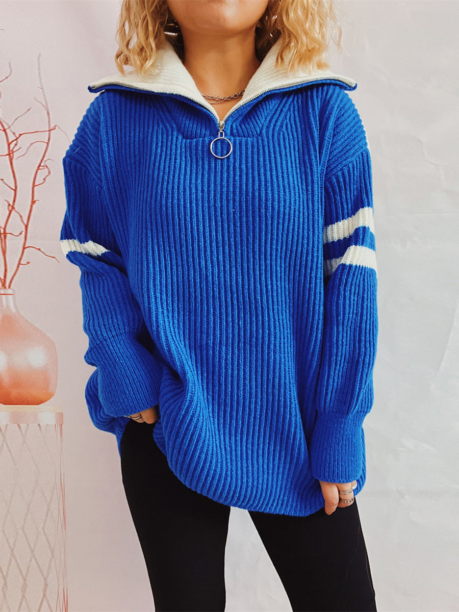 Royal blue ribbed knit sweater with white varsity stripes on sleeves and a white zippered collar.