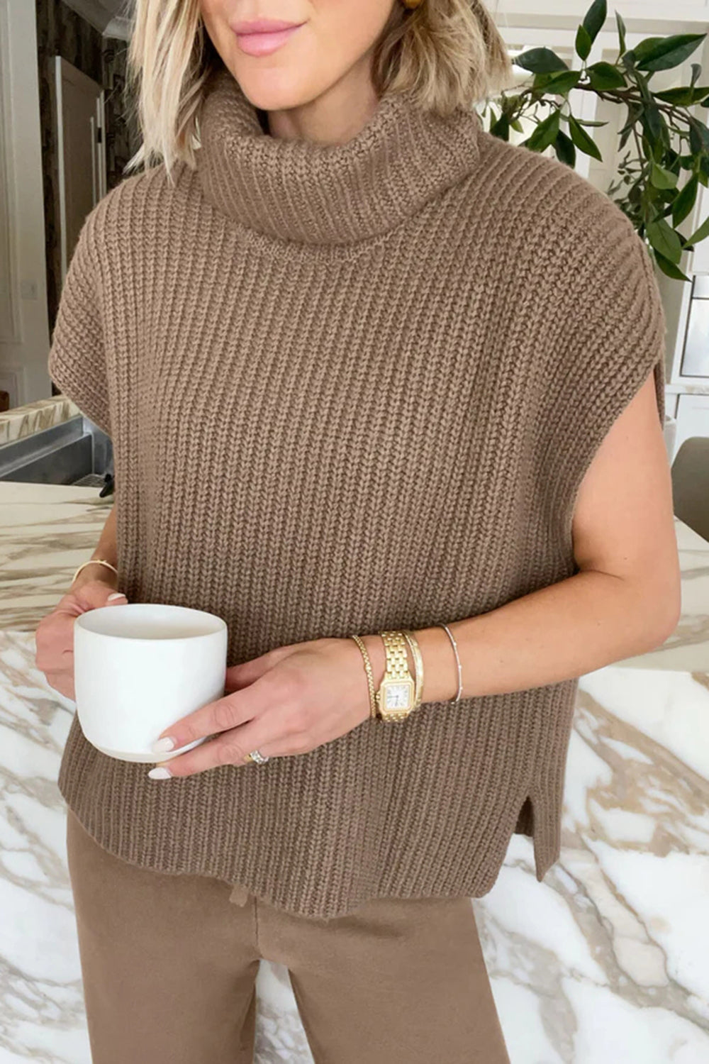 Sleeveless ribbed turtleneck sweater in taupe, with a relaxed fit and side slits.